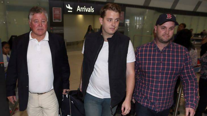 Jack Walker, centre, and his father John Walker, left, arrive at Perth international airport on Friday afternoon. Photo: Diimex