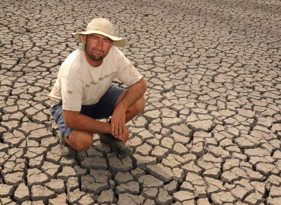 Oxley Island dairy farmer Pat Neal pictured with one of his dry, parched dams.