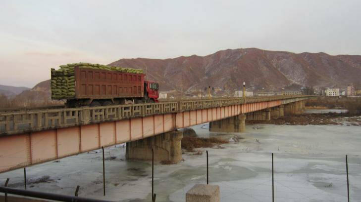Hard land: a loaded truck crosses the Tumen River from China into North Korea. Photo: Philip Wen