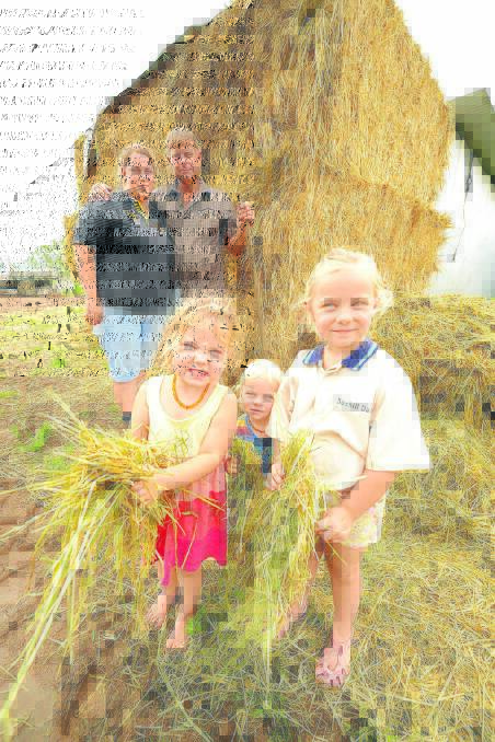 Natasha and Rod Yarrington and their young children, Rylee, Jack and Alexis, with the load of hay they have bought in to feed their dairy cattle. More hay is on the way in a couple of weeks.
