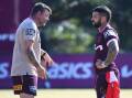 Brisbane's assistant coach Lee Briers talks tactics with captain Adam Reynolds. (Jono Searle/AAP PHOTOS)