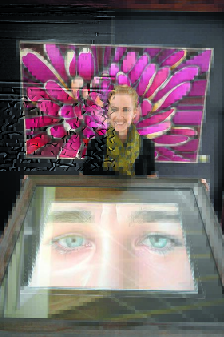 Jenna Ryan pictured with a mixture of her hyperealistic work and new bolder artworks.