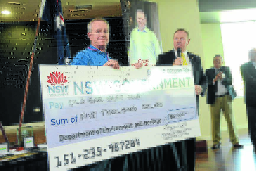 Taree Old Bar SLSC member  accepts a cheque from Myall Lakes MP Stephen Bromhead at an awards presentation last weekend.