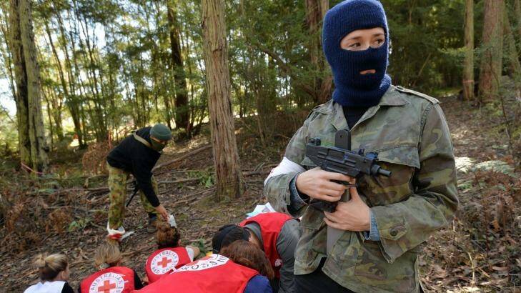 Under threat. A team of Red Cross aid workers are "captured" at a hostile environment training camp in Yellingbo, east of Melbourne. Photo: Joe Armao