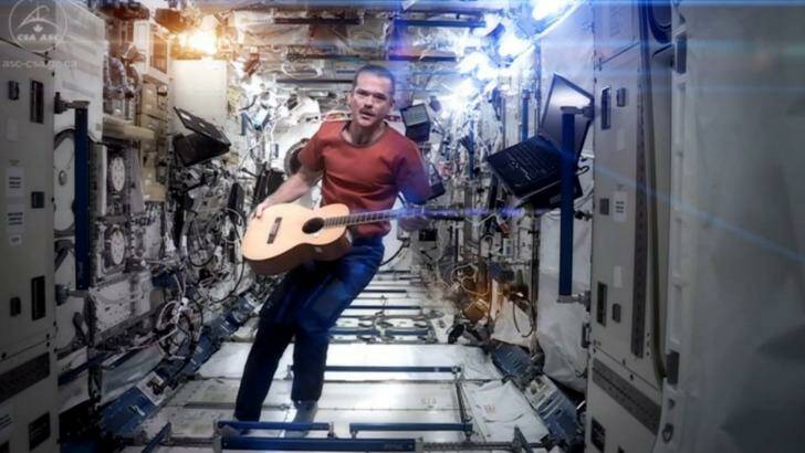 Then ISS Commander Chris Hadfield performs his zero-gravity version of David Bowie's <i>Space Oddity </i>. Photo: NASA/Reuters