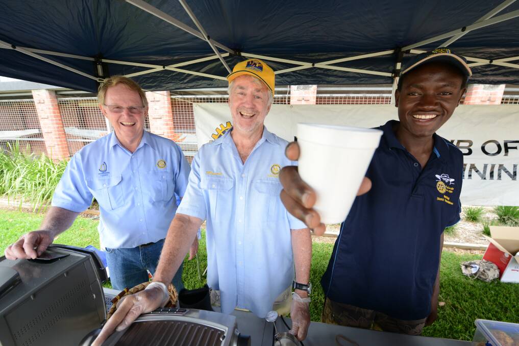 Linus Faustin (right) offered piping hot coffee to passers-by on Rotary's riverbank stall.