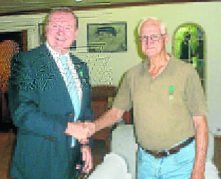 Member for Myall Lakes Stephen Bromhead congratulates John Baker on receiving his long service medal from the Nationals.