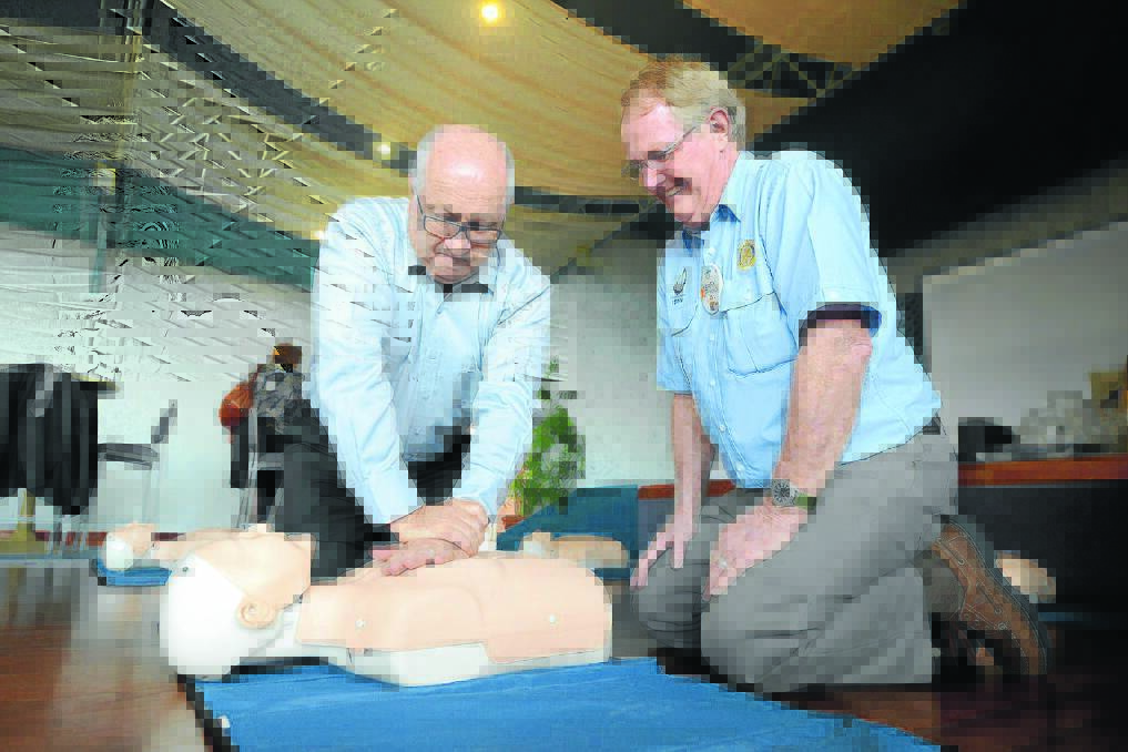 Having a go: Taree on Manning Rotary Club president Alan Tickle, getting CPR instructions from Rotarian and Rural Fire Service community safety officer, Terry Kitching.