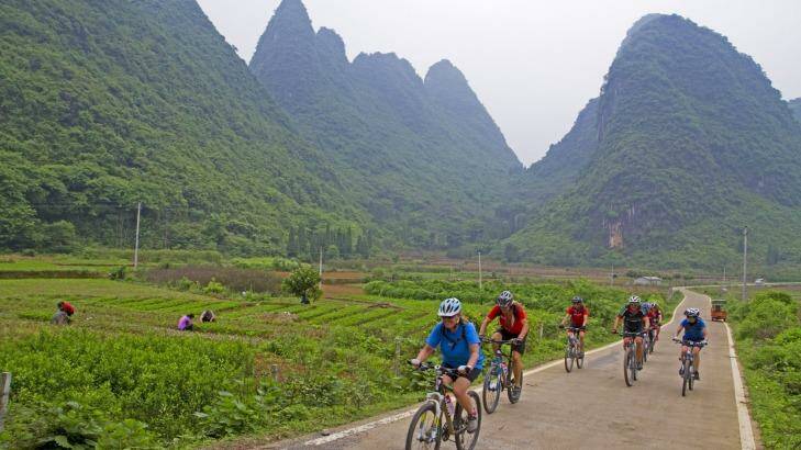Cycling past limestone peaks near Xingping Yangshou. Photo: Andrew Bain