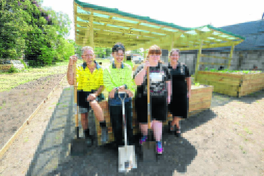 Taree Community Garden is a "fabulous" project that is teaching Novaskill workers new skills and cultivating teamwork, according to branch co-ordinator Tess Jones (right). Scott Beatty (left) leads the team of enthusiastic workers that includes Jimmy Linke and Natasha Roberts.