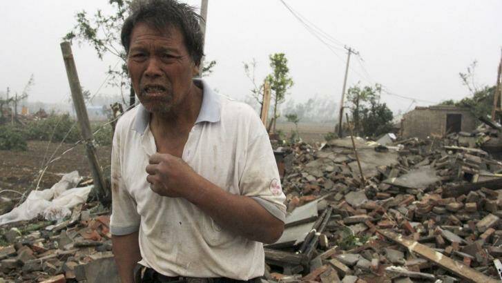 A villager stands near houses destroyed by a tornado that hit the Chinese province of Jiangsu on Thursday. Photo: Color China Photo via AP