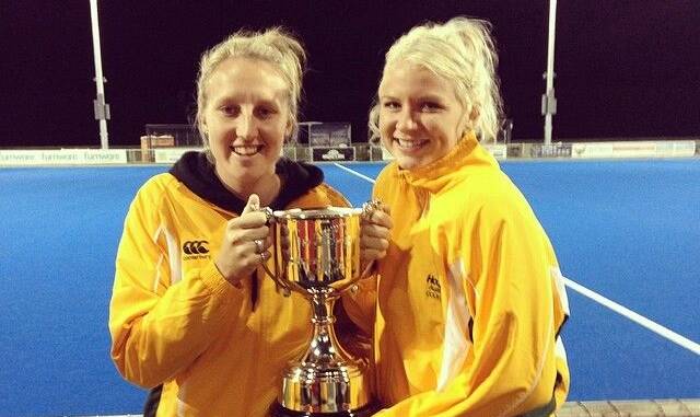 Holli Wheeler and team-mate Chrissee Benn hold the trophy the Australians won as the most successful team in the New Zealand tournament.