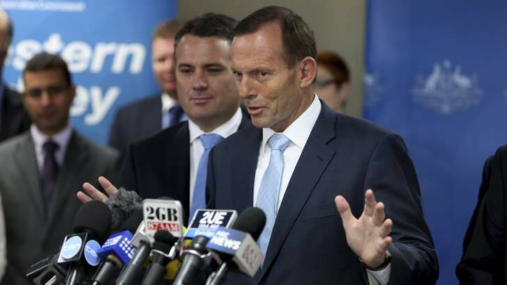 Tony Abbott tries to talk about infrastructure instead of Barry O'Farrell at Liverpool Council on Wednesday. Photo: Sasha Woolley