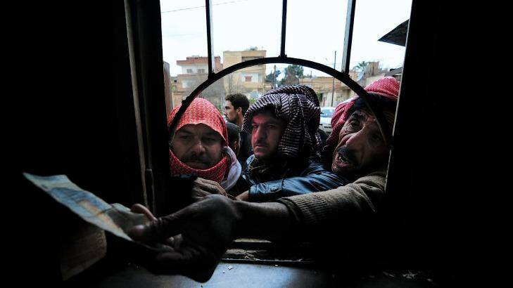 Residents of Tel Tamer line up for bread during a lull in the fighting. Photo: Fadi Yeni Turk