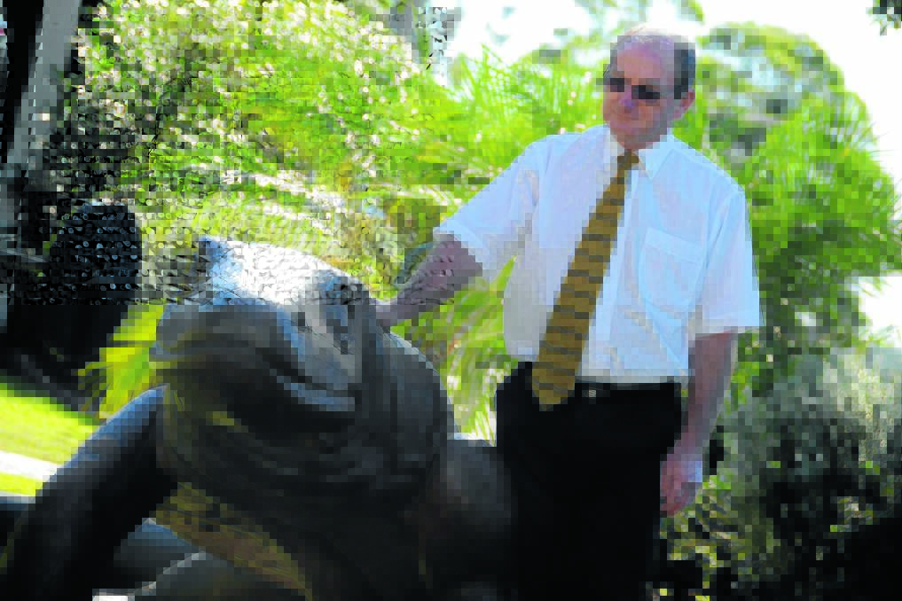 Taree businessman and Tidy Up Taree organiser, Graham Brown with the timber goanna, currently located in the grounds of Manning Regional Art Gallery but destined to take centre stage in Taree's main street.