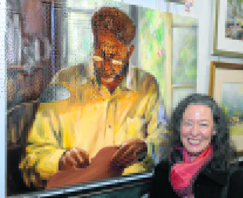 Jo Ernst with one of her portraits from last year's Taree Open Art Exhibition.