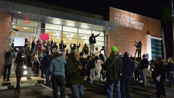 Protesters outside the Ferguson Police Department following the resignation of Ferguson Police Chief Tom Jackson earlier in the day.    Photo: Michael B. Thomas/AFP