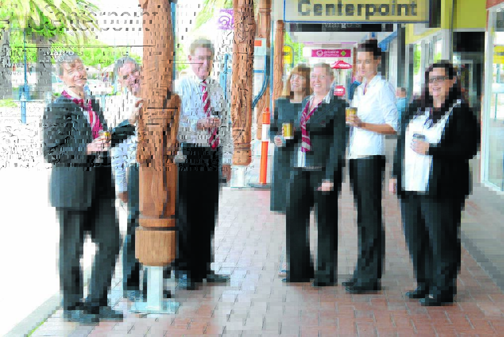 Pictured: The tallowwood logs at Centerpoint Arcade feature carved goannas and prompt people to stop to admire the work of acclaimed Aboriginal artist, Russell Saunders. The logs caught the eye of (from left) Joanne Godwin, Alister Currie, Murray Robinson, Elizabeth Firmager, Nicole Wiffen, Samantha Pruim and Lisa Emerton on the day they were installed in Victoria Street.