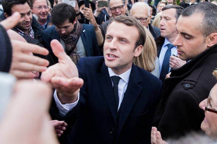 Emmanuel Macron, France's independent presidential candidate, greets supporters after voting at a polling station during the first round of the French presidential election in Le Touquet, France, on Sunday, April 23, 2017. French voters are heading to the polls to select two presidential candidates for the runoff round of the 2017 election, whose results have the potential to determine how far the populist wave in Europe will go. Photographer: Christophe Morin/Bloomberg Photo: Christophe Morin