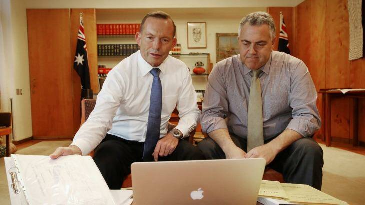 Prime Minister Tony Abbott poses with Treasurer Joe Hockey as they look through the 2015 budget. Photo: Andrew Meares