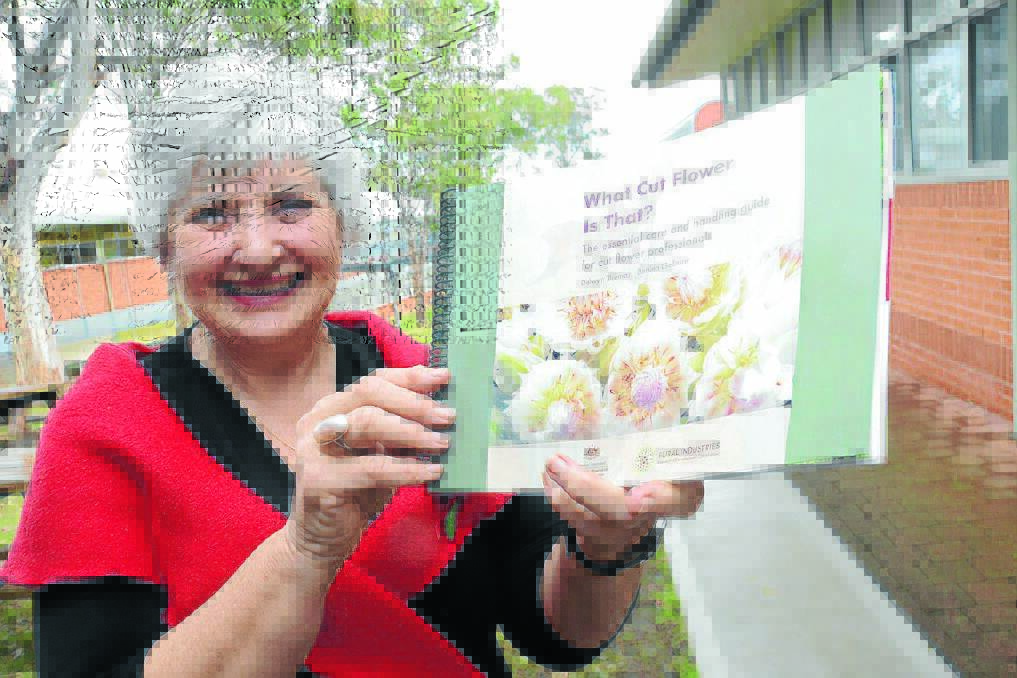 Del Thomas with the book "What Cut Flower Is That?" which she co-authored.
