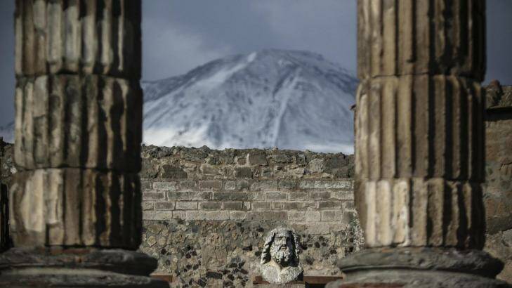 The snow-covered peak of Mount Vesuvius volcano is seen from the archaeological excavations of Pompeii in Naples, southern Italy.