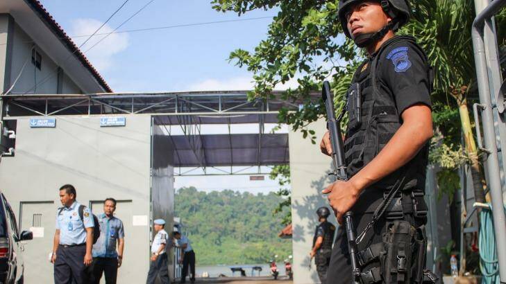 Nusakambangan, the island where the executions will take place, is visible through the gate as police wait for ambulances to arrive. Photo: Wagino