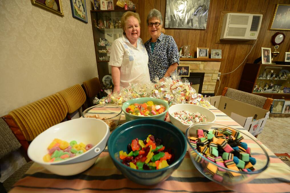 Pictured: Lions ladies, Margaret Rogers and Barbara Smith bag lollies destined to children living in drought-stricken parts of our State.