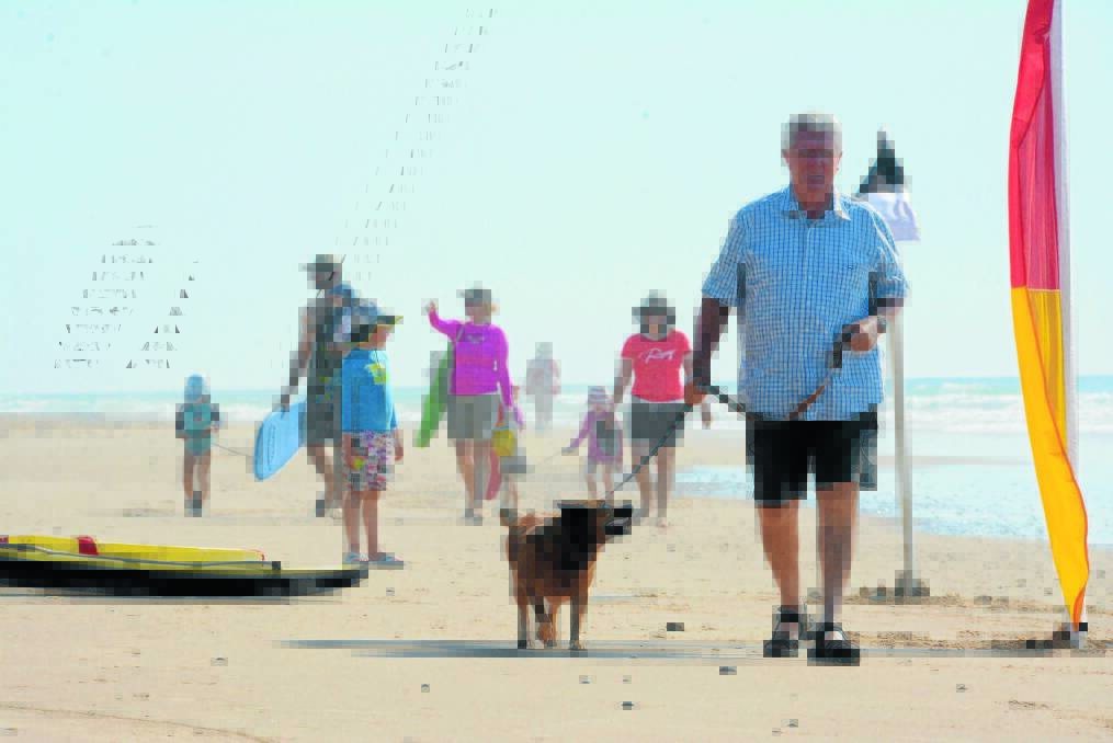 Greater Taree City mayor, Paul Hogan and Georgie, on the lead through the patrolled area of Old Bar Beach. Dogs are now allowed off the leash away from patrolled zones on most beaches in Greater Taree City Council.