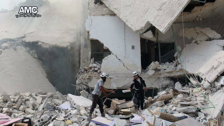 A photo provided by the Syrian anti-government  Aleppo Media Center  shows Syrian civil defence workers inspecting ruined buildings after regime air strikes in the city in August. Photo: Aleppo Media Center via AP