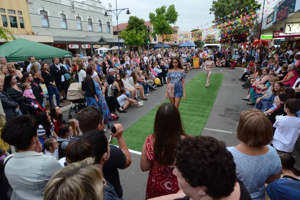 The crowd surrounds the annual Iguana Surfwear Fashion Parade at the Taree Night Bazaar. Iguana Surfwear decorated its end of the street with rainbow flags and lights that were a hit with those taking photos for Instagram on the night.