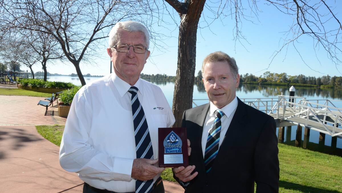 Resignation accepted with regret: Greater Taree City mayor Paul Hogan, who recently resigned from MidCoast Water’s board, and MidCoast Water’s general manager, Robert Loadsman, with the plaque.