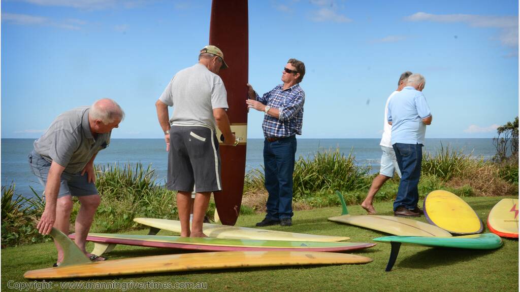 Some of the originals: Former Saltwater Boardriders Club members Peter Muxlow, Col Nelson, Phil Rowsell, Sid Gilfillan, Graham Tyrie, Lou Northam and Lachie Eggins look over some surfboards from their vintage. The club marks its 50th anniversary this weekend.