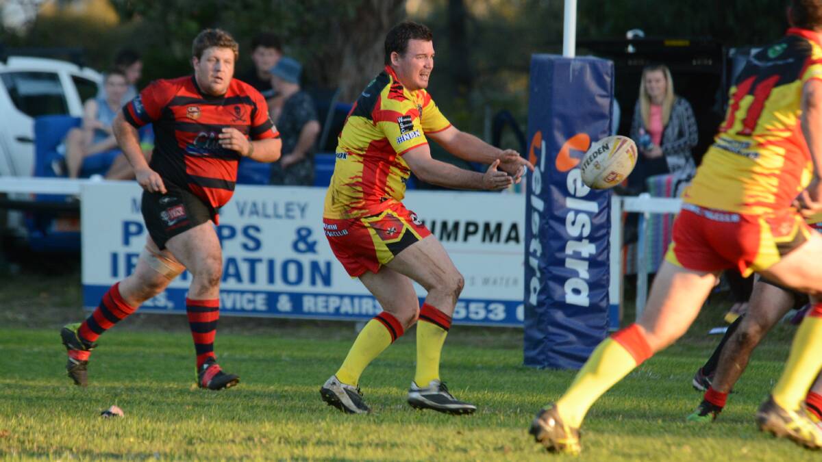 Wingham halfback Luke Steel offloads during the Group Three Rugby League game against Taree City at Wingham.