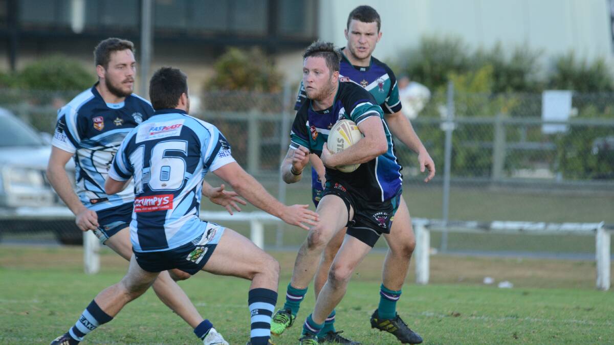 Taree City fullback Daniel Morris is about to be taken by Port City defenders in the Group Three Rugby League game at Taree. The Breakers won 44-20.