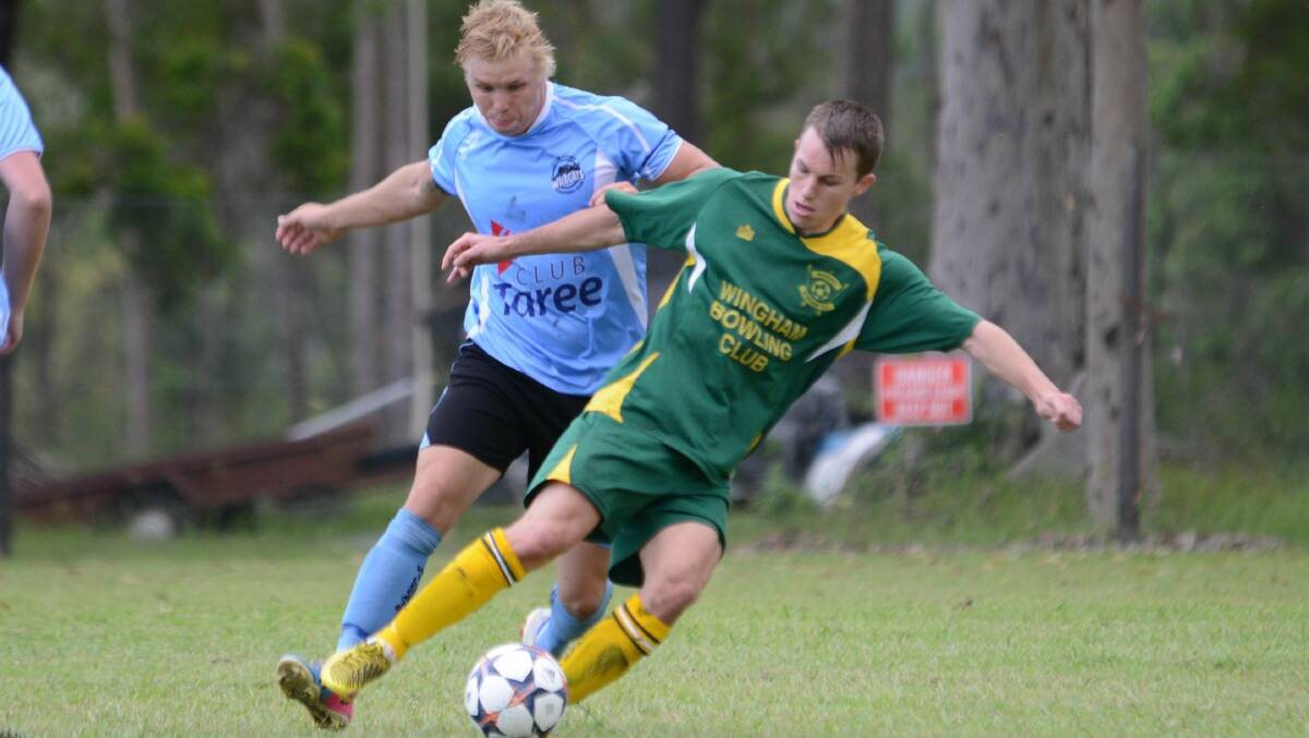 Taree's Jackson Witt challenges Wingham's Mitch Bevitt during a Football Mid North Coast Premier League clash last season. All senior clubs within  Football Mid North Coast will have to nominate an official to complete a referee's course before the start of the 2015 season.
