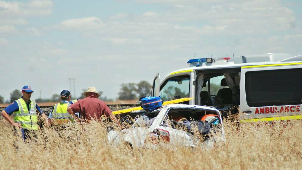 DUBBO NSW Ambulance paramedics at the scene of the accident east of Trangie at 1pm Monday afternoon. Photo GRACE RYAN