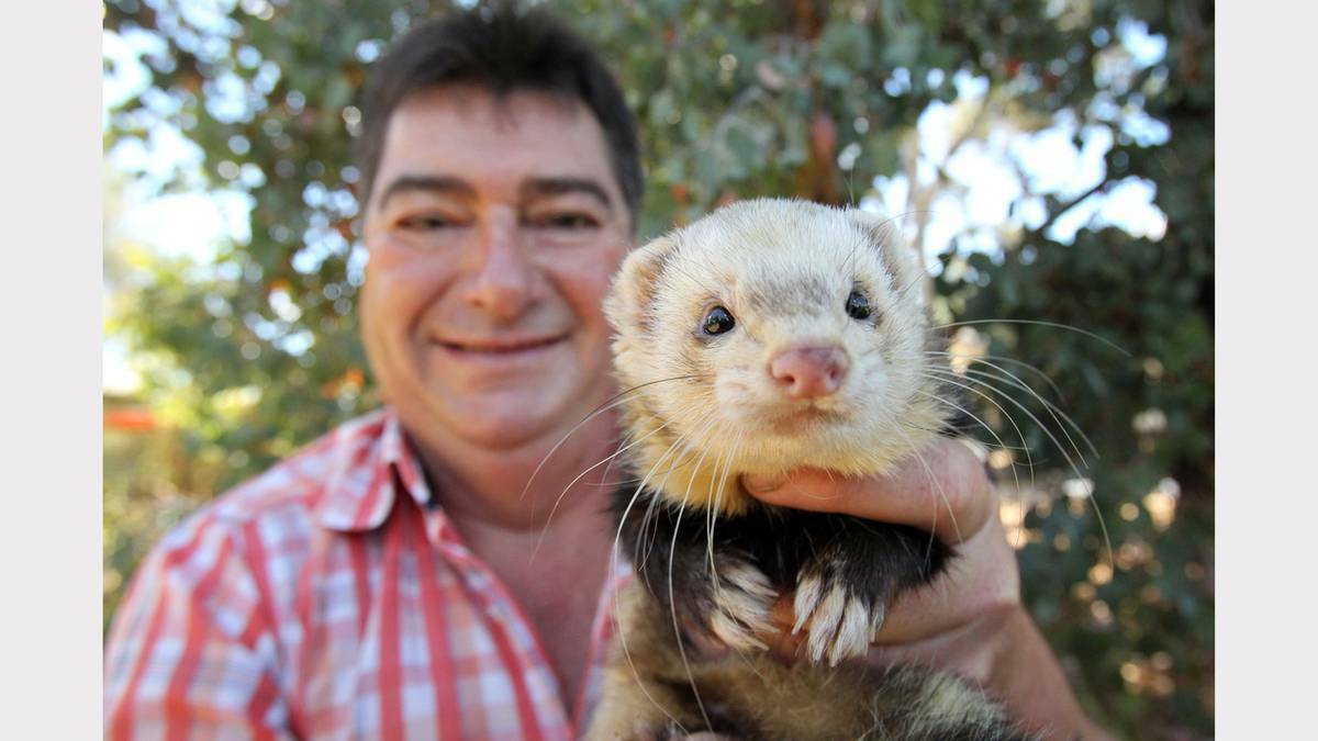 Wodonga's Garry Knight with his pet ferret 'Buckley', 18 months old. Picture MARK JESSER