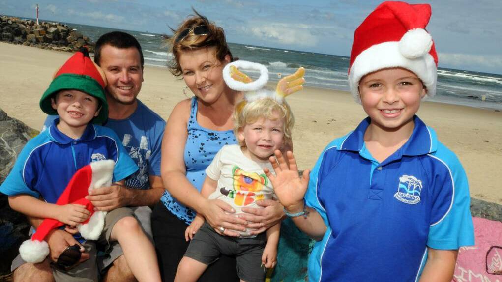 Chris and Melanie Hickling with Owen, George and Arlo preparing for Christmas on the Beach. Picture: Port Macquarie News.