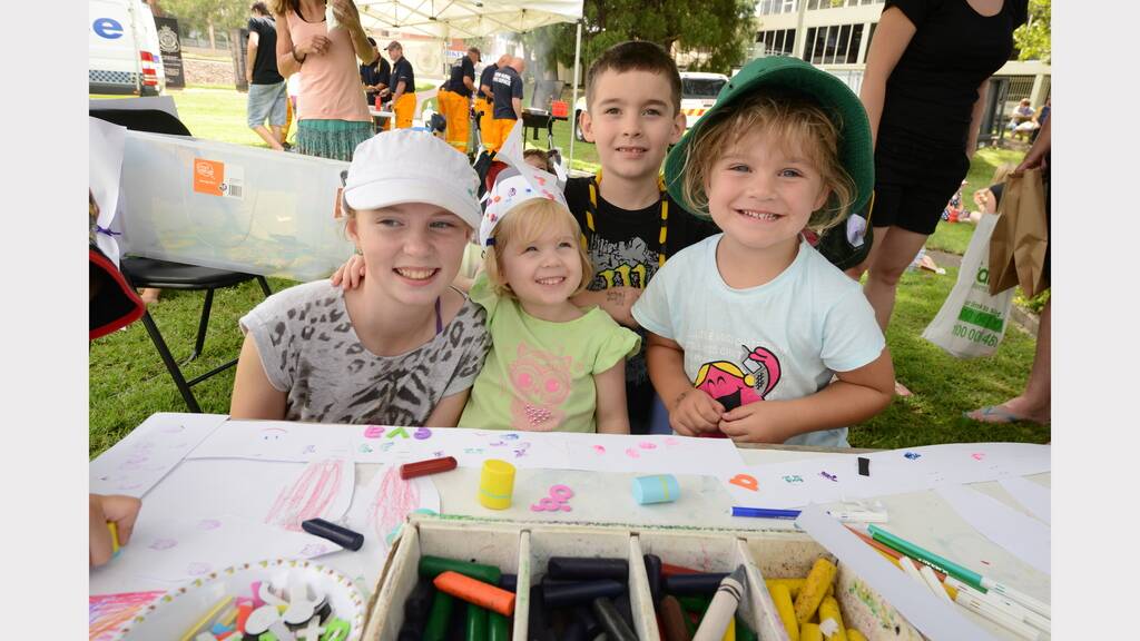 A box of bright crayons at a craft table delighted Willow Christiansen, Eva-Lafaye Christiansen, Seth Christiansen and Amanda Bevan at the Mid North Coast Family Referral Service Family Fun Day in Taree.