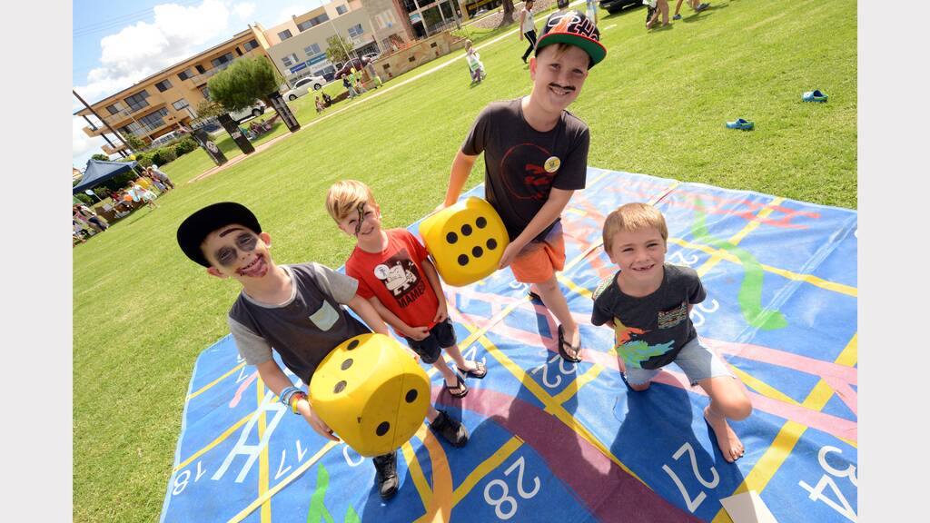 A giant game of snakes and ladders delighted Cooper, Fletcher and Oscar Holt and Sam Eggins at the Mid North Coast Family Referral Service Family Fun Day in Taree.