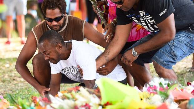 Grief stricken loved ones visit the shrine for the eight children killed in Cairns. Photo: Ian Hitchcock/Getty Images 