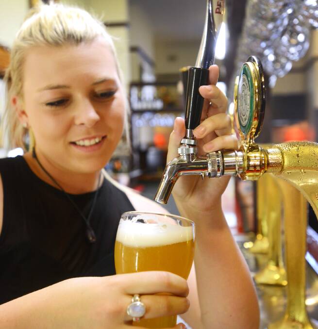 THUGS OFF TAP: Barmaid Taylor Anderson-Sykes pours a beer at the Tamworth Hotel. New figures have revealed sweeping changes to the way local pubs operate have dramatically reduced CBD violence. Photo: Barry Smith  281014BSF12