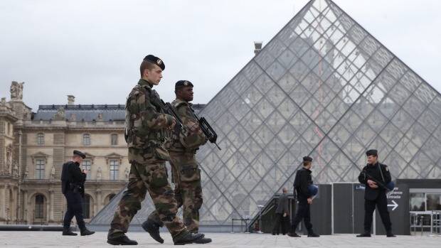 According to Manning Valley resident Micaela Hagan, who was in France following the Paris Attacks, police and security were nearly everywhere, particularly near the monuments like the Eiffel Tower. French military and police patrol the Louvre in Paris Photo: Andrew Meares, SMH
