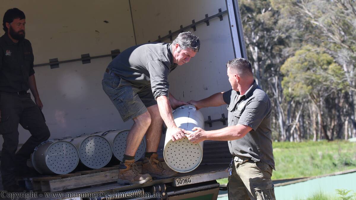 LOADING UP: Devil Ark keeper Dean Reid simulates loading the truck of Tasmanian devils with Devil Ark operations manager Mike Drinkwater. The pair drove the devils to Scone Airport on Wednesday November 18.  