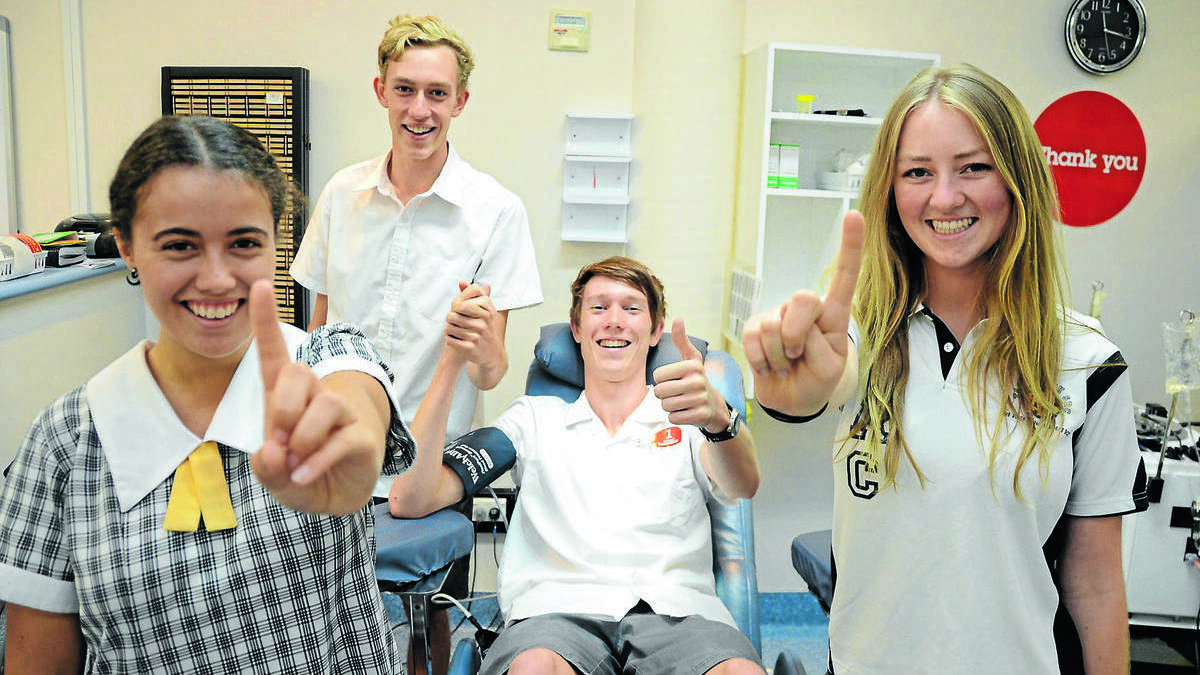 First time blood donor Zac Calvin gives a thumbs-up to the new one donation per year policy. Supporting him are Tom Fletcher, and Australian Red Cross blood ambassadors, Holly Pole-Cini (left) and Amani Jensen-Bentley (right).