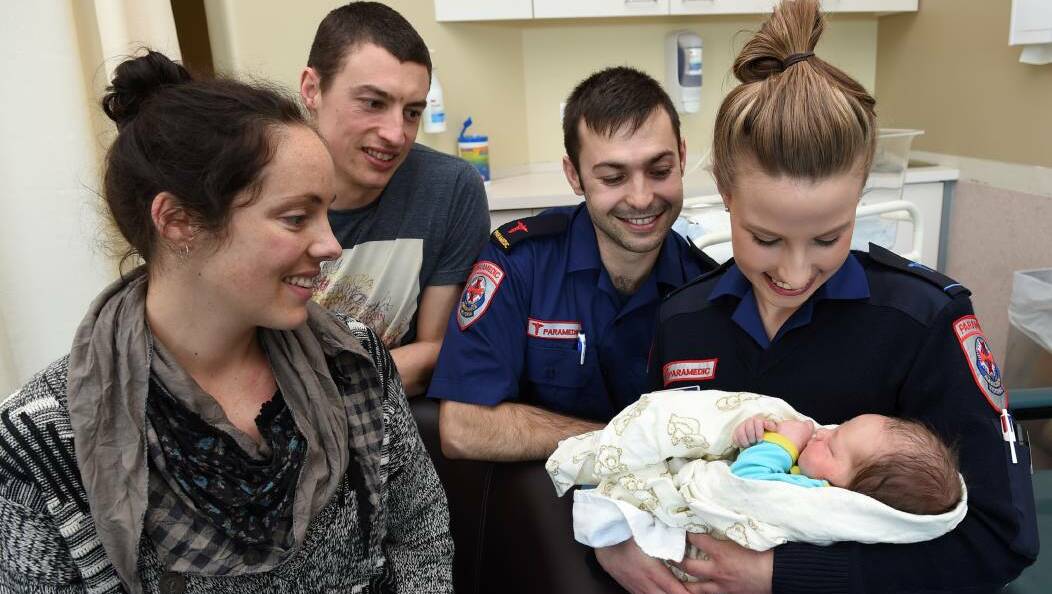Lindy and Matt Sharkey welcomed baby Cooper into the world on Monday night. The baby was born in an ambulance with the assistance of paramedics Mitch Ridgway and Emma Dean. Picture: Lachlan Bence
