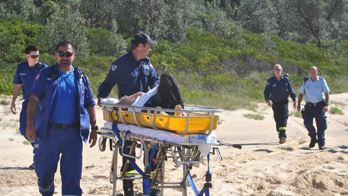 ULLADULLA: Paramedics, police and NSW Fire and Rescue personnel attend to injured bodyboarder John Wolfson after his collision with a dolphin near Bawley Point on Monday.