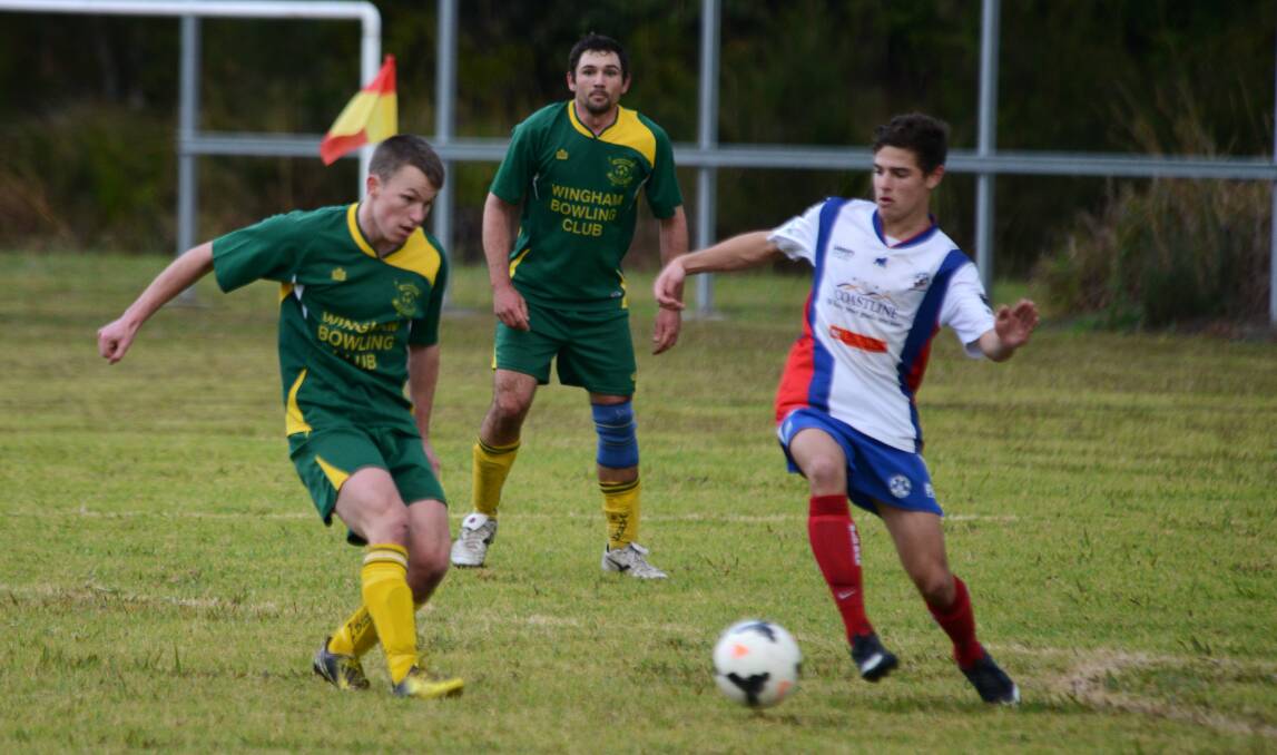 Wingham's Mitch Bevitt takes on Old Bar's Nathan Somerville in Saturday's premier league game at Old Bar.