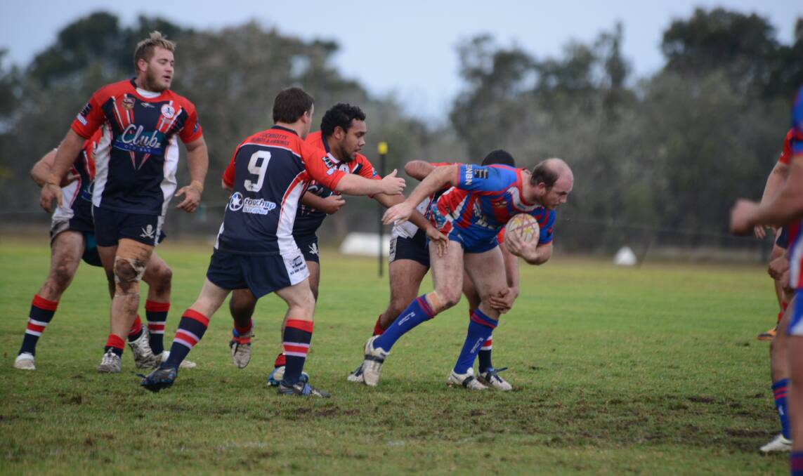 Wauchope captain-coach Rob Trembath breaks through Old Bar's defence during the match at Old Bar on Saturday, July 26.